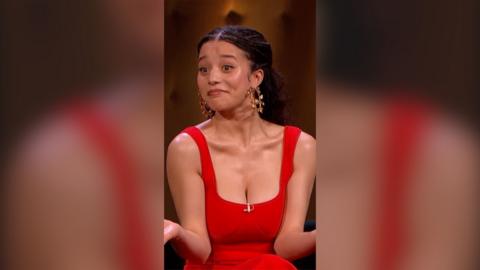 Chase Infiniti has long dark hair and is wearing a red sleeveless dress.