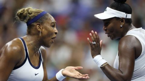 Serena and Venus Williams celebrate winning a point at the 2026 US Open