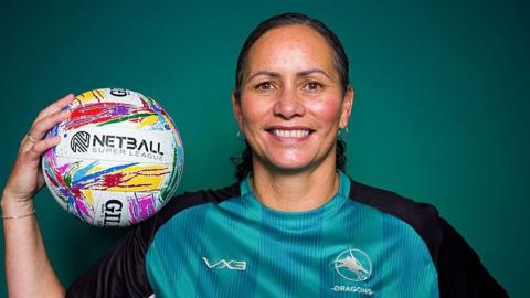 Reinga Bloxham holding a netball and wearing a LexisNexis Dragons shirt