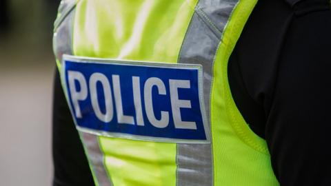 Back of police officer's hi-vis uniform.