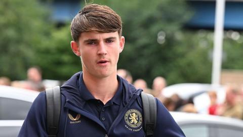 Jack Daley arriving for a game in a dark blue Middlesbrough tracksuit top and with a black rucksack over his shoulders