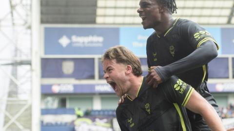 Freddie Draper celebrates his goal for Lincoln at Preston
