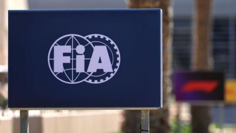 The FIA logo on a board at the side of the track during testing in Bahrain