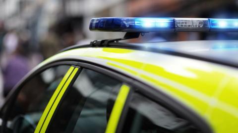 A police car with its blue lights on.