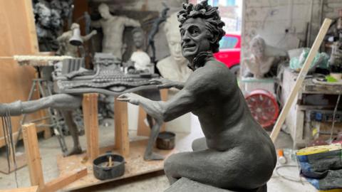 The statue presents Terry as the organist, nude apart from a flapping tie and 'exploded' hair, grinning as he strikes the classic pose.