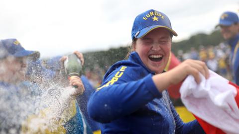 Lottie Woad is doused in champagne as she celebrates Europe's Solheim Cup victory