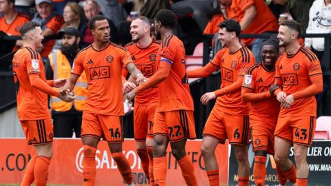 Salford players celebrate Joe Powell's winner against Port Vale