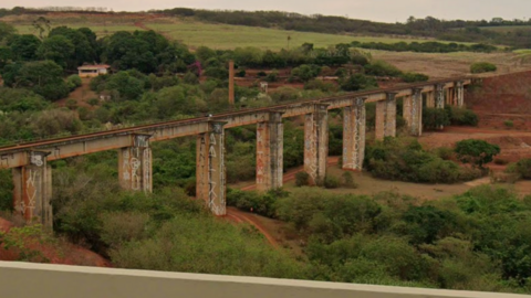 A landscape view of the abandoned bridge in Ponte do Esqueleto with fields surrounded the infastructure