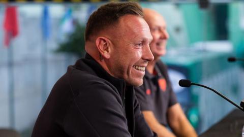 Craig Bellamy smiles at his pre-match press conference