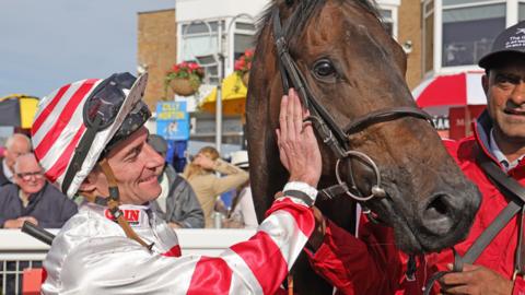 Jockey Danny Tudhope and Pellitory after winning the Ladbrokes Ayr Gold Cup at Ayr Racecourse.