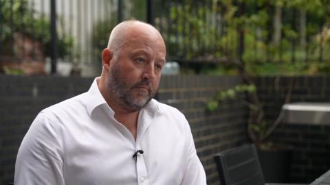 A man in a white shirt.