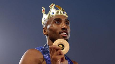 Gold medalist Matthew Hudson-Smith posing for a photo with his medal after victory in the Men's 400 Metres Final