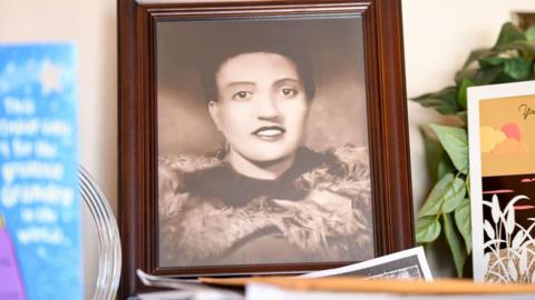 A portrait of Lacks in a picture frame on a desk