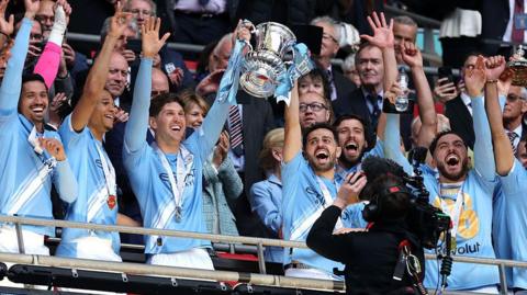 Manchester City players lift the FA Cup
