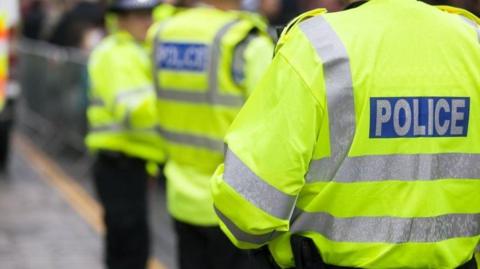 Three police officers wearing hi-vis jackets