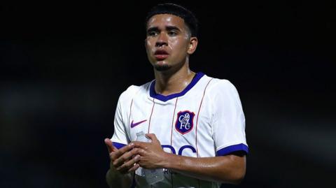 Kendry Paez clapping the travelling fans while holding a water bottle