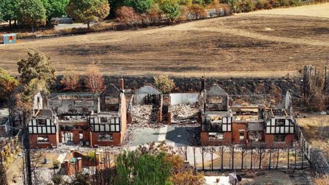 An aerial view of destroyed homes after the Stourbridge wildfire on August 21,
