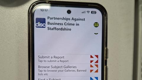 A close-up of an app open on a mobile phone. Across the top it says Partnerships Against Business Crime in Staffordshire