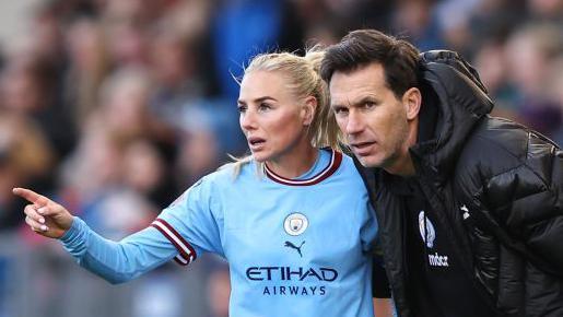 Alex Greenwood speaking to Manchester City Women's head coach Gareth Taylor