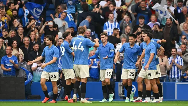 Pascal Gross of Brighton and Hove Albion celebrates with his teammates