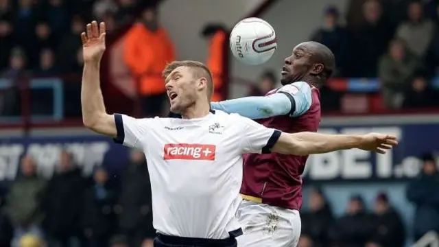 West Ham's Carlton Cole and Millwall's Darren Ward contest a header in the last meeting between the sides in February 2012.