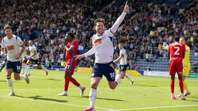 Callum Lang celebrates by raising his left arm after scoring against Blackburn Rovers on Saturday