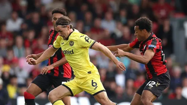 Yarmolyuk of Brentford is challenged by Tyler Adams of Bournemouth