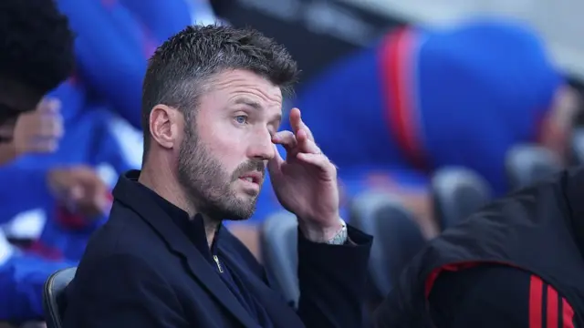Michael Carrick, manager of Manchester United, looks on