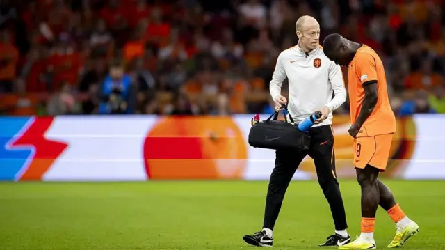 Netherlands' Brian Brobbey walks off with an injury