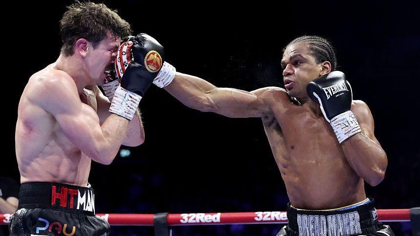 Gerome Warburton lands a punch on Nathan Heaney