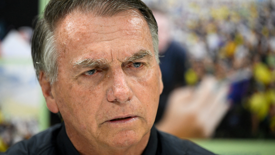 Former Brazilian President Jair Bolsonaro pictured from the neck up during an interview with Reuters in Brasilia, Brazil, on July 18, 2025. He is wearing a dark shirt and has a stern expression.
