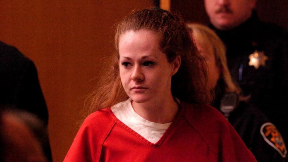 Christa Pike appears in court in 2007 wearing an orange prison shirt