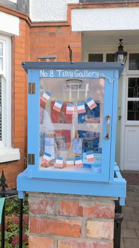 The tiny gallery outside Max's home