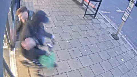 CCTV Image: Plain clothed police officer tackles thief fleeing from a shop on an e-scooter 