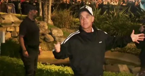 Robbie Williams with his fans in the background in Peru