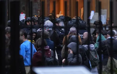 Getty Images Police arrest protesters at Columbia University on 5 March 