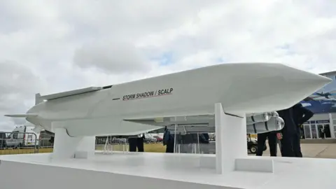 Getty Images A Storm Shadow missile rests on a plinth, displayed during the Farnborough International Airshow in July 2024. 