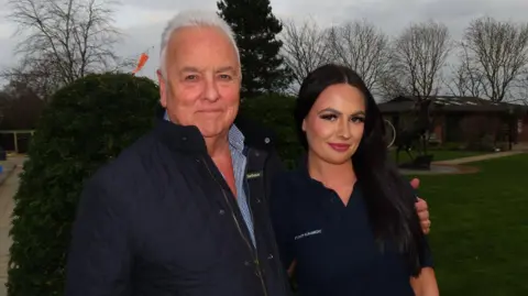 An image of Hannah Standing, stood with her father, Conway