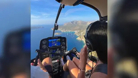 Hannah Standing An image of Hannah Standing driving a helicopter in Spain