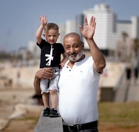 Adult and child greeting in a public space.