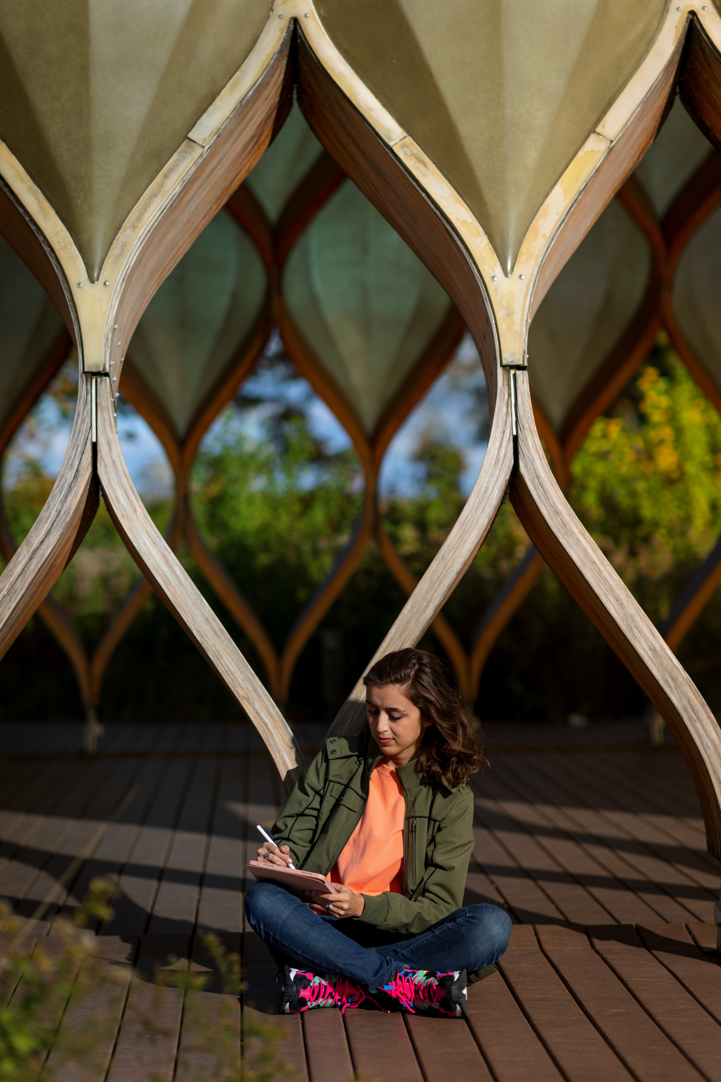 Author Cassidy sitting outside working on her tablet