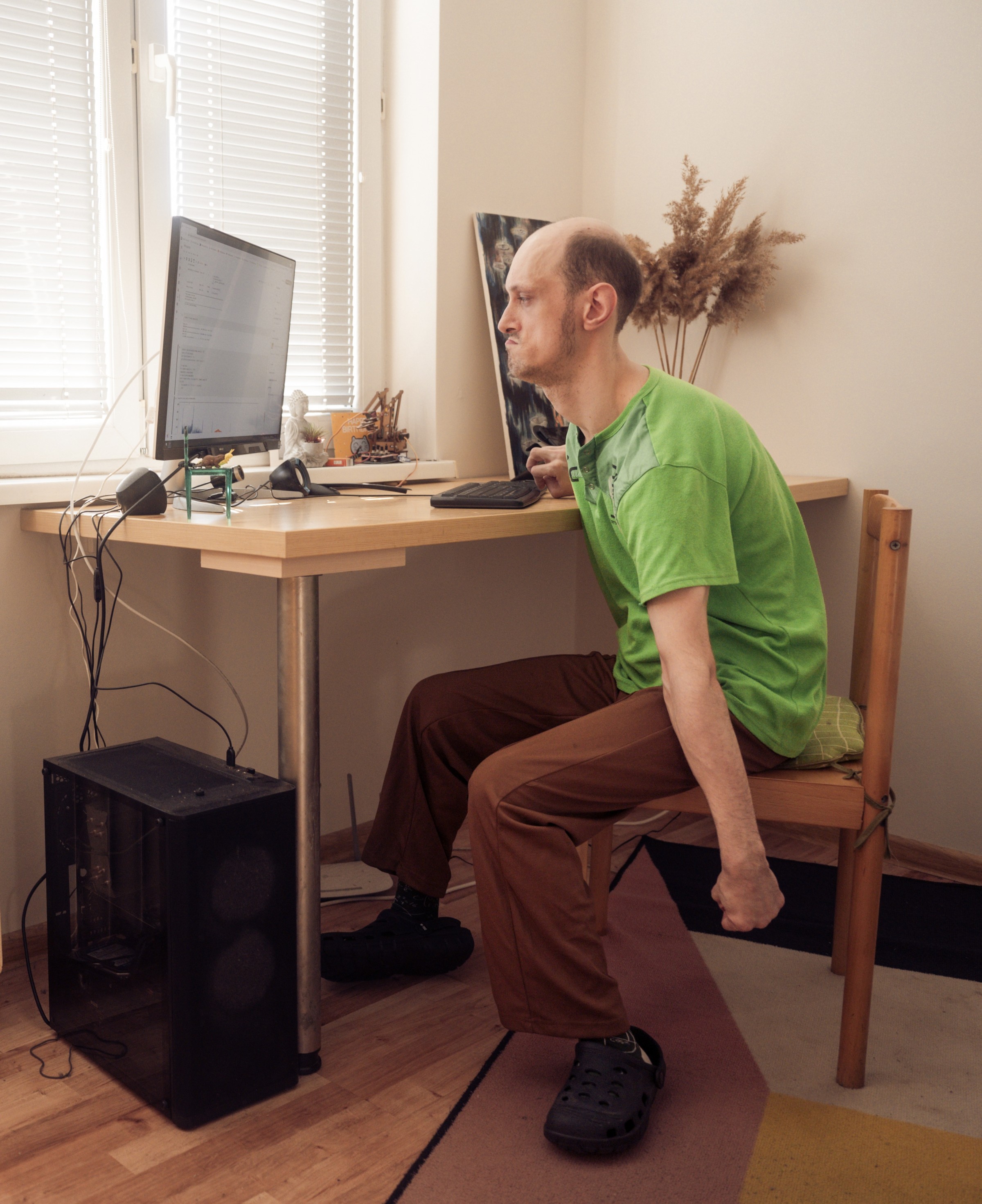 Anton sits at his desk coding. 