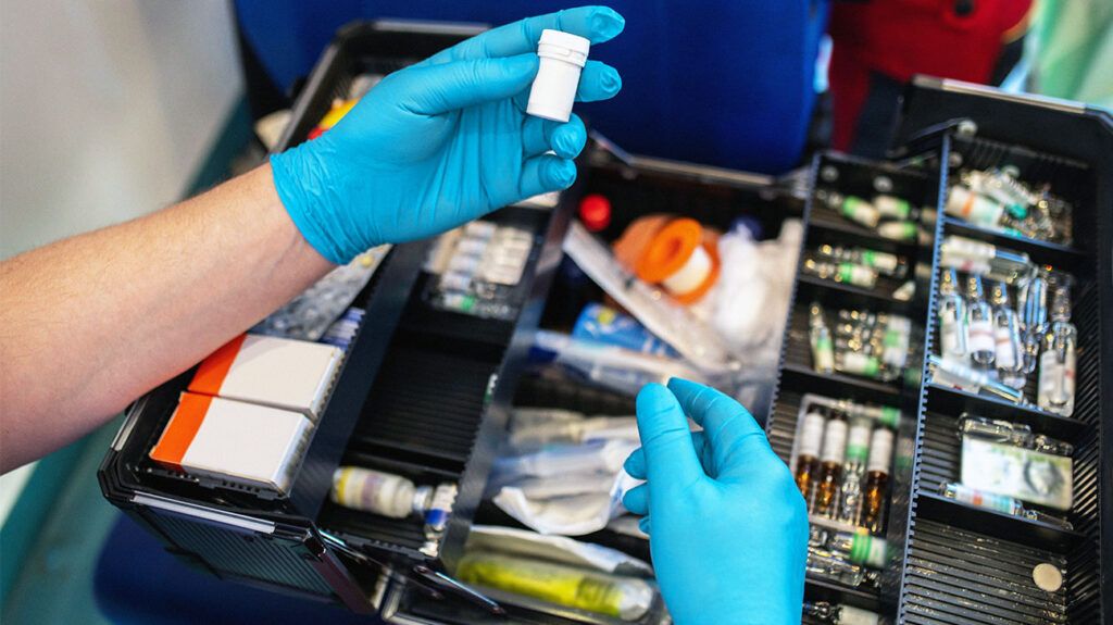 Paramedic choosing a medicine for a patient
