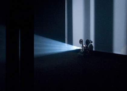 Explanded cinema showing a projector with streaming light