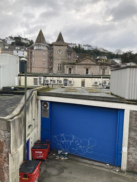 Lock up, graffiti, rubbish and the towers of Tor Haven, Torquay