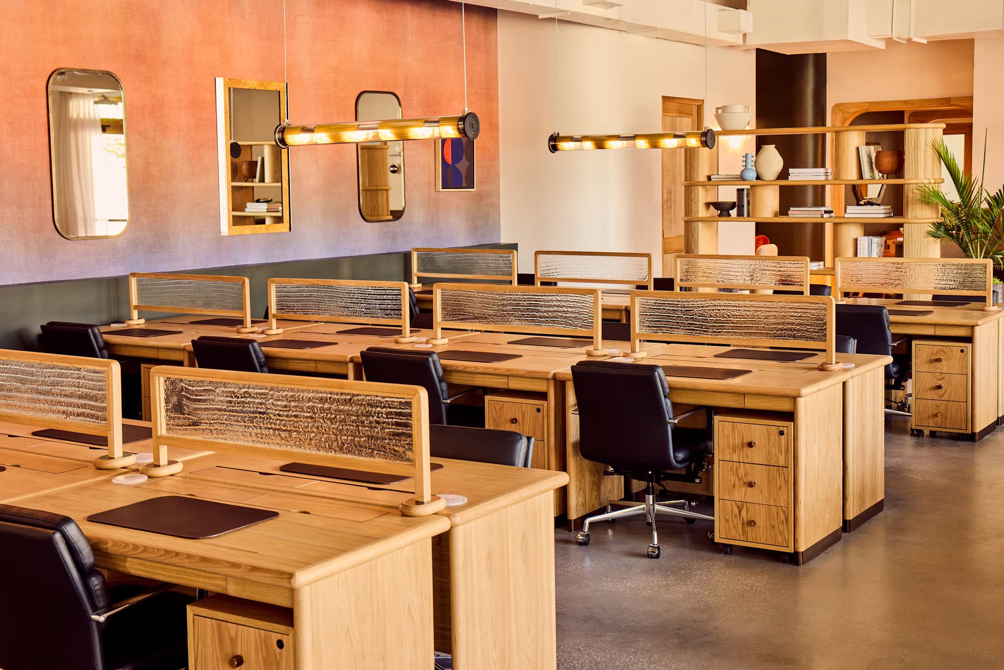 Private dedicated desk area with warm wood finishes at The Malin East Austin
