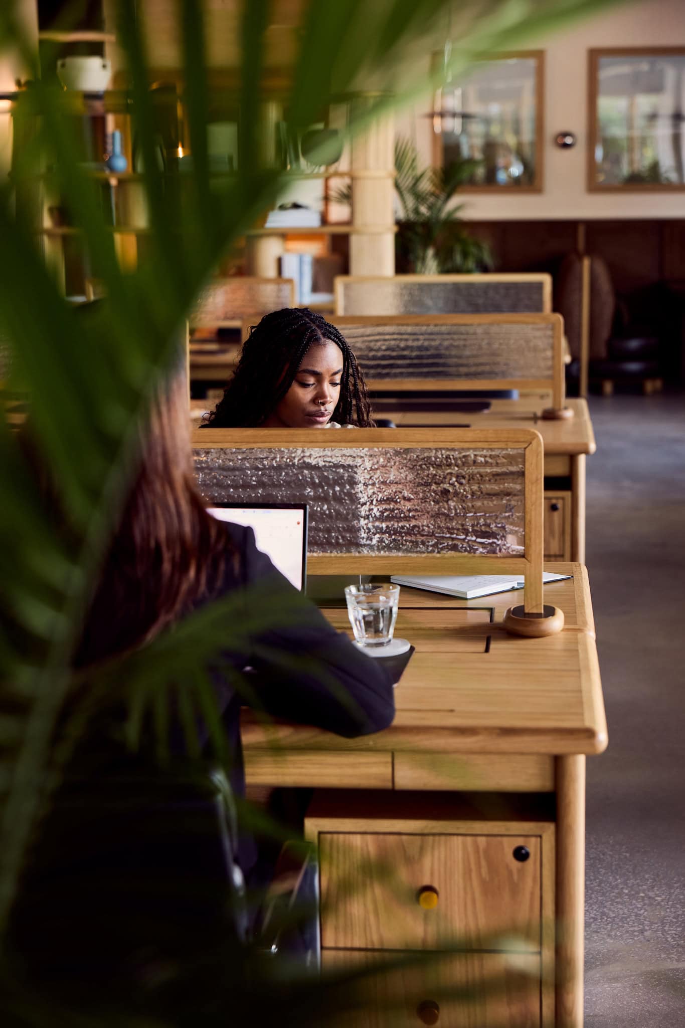 Quiet dedicated desk area with wood dividers at The Malin East Austin