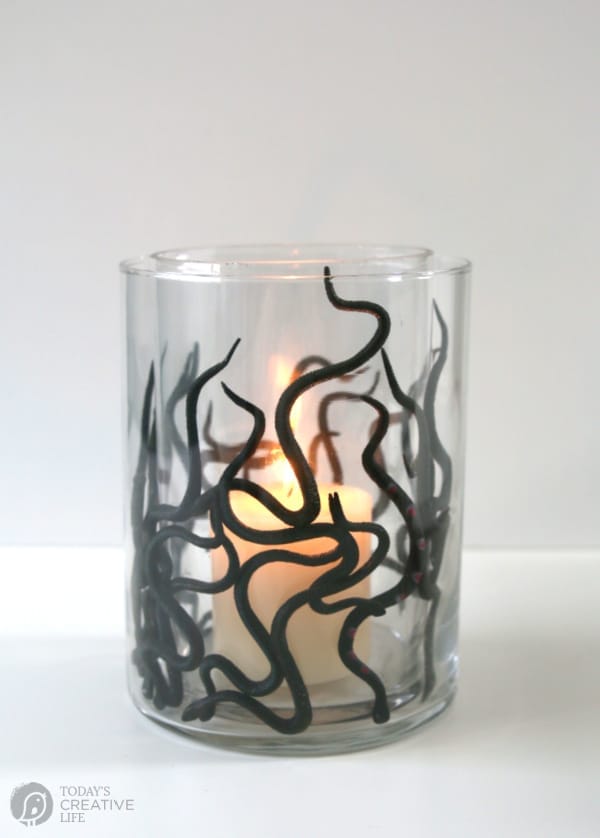 Glass Vase filled with plastic black snakes for a DIY Halloween Centerpiece