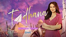 An image of Marian Rivera wearing a pink top, with several monuments, a purple sky and clouds on the background. The series title is displayed on the center of the image. The texts "Saturday • 3:15 PM" are displayed below the series title. The logo of GMA Network is displayed on the lower part of the image.