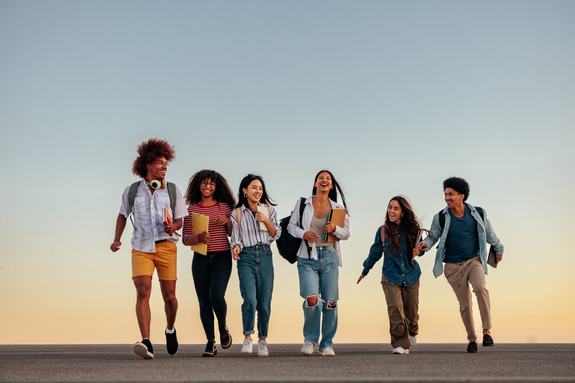 Secondary Socialization 1 A group of students laughing and walking together between classes to show a type of secondary socialization